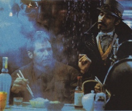 Gaff interrupts Deckard's dinner at the noodle bar